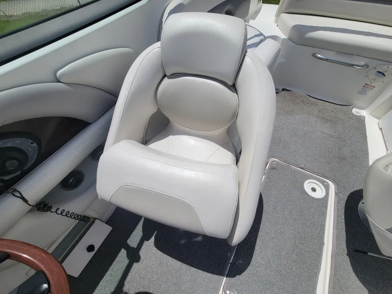 Slide: The Image of 2007 Chaparral Sunesta 214 boat interior with white cushioned seating and gray carpet. - 14