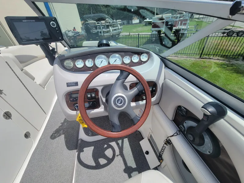 Slide: The Image of 2007 Chaparral Sunesta 214 boat dashboard with steering wheel and control panel. - 16