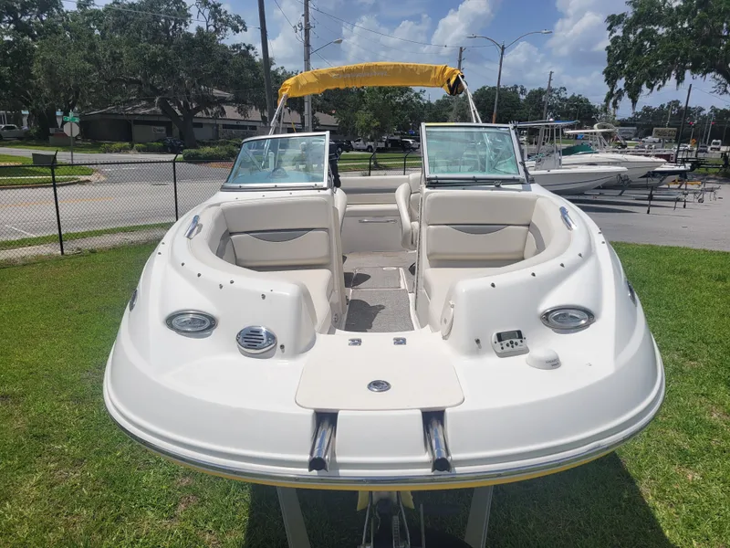 Slide: The Image of 2007 Chaparral Sunesta 214 boat with yellow canopy on grassy area, sunny day. - 2