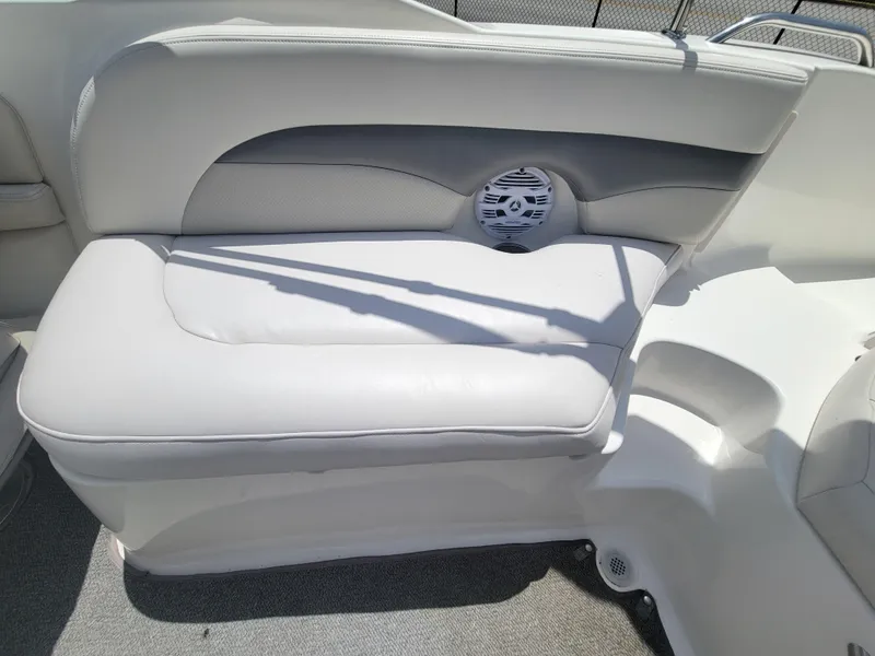 Slide: The Image of 2007 Chaparral Sunesta 214 boat interior with white cushioned seating and speaker. - 20