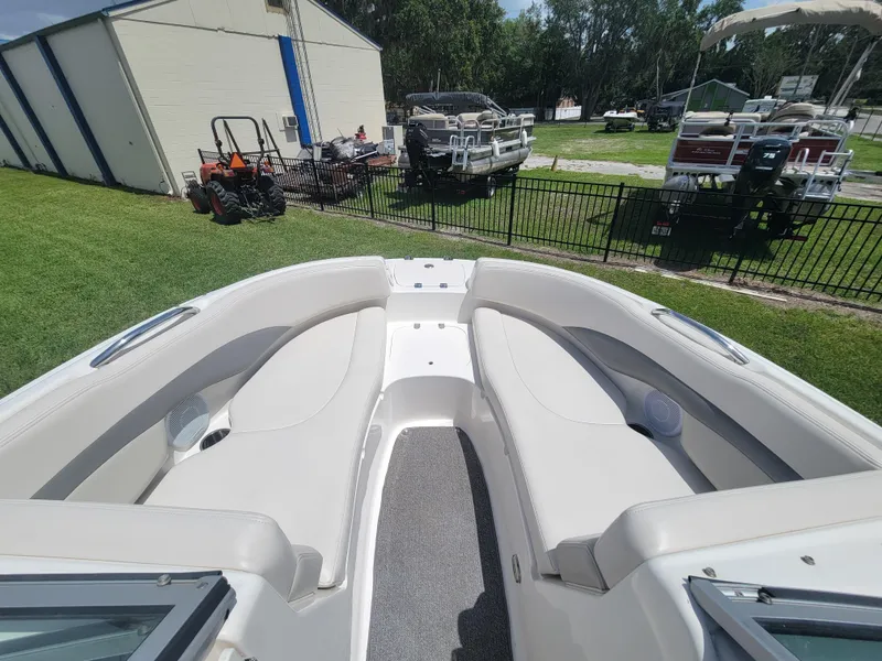 Slide: The Image of 2007 Chaparral Sunesta 214 boat interior with white seating and outdoor storage view. - 21