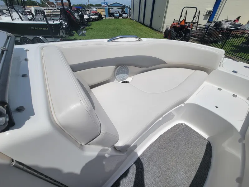 Slide: The Image of 2007 Chaparral Sunesta 214 boat interior with white seating and speaker detail. - 23