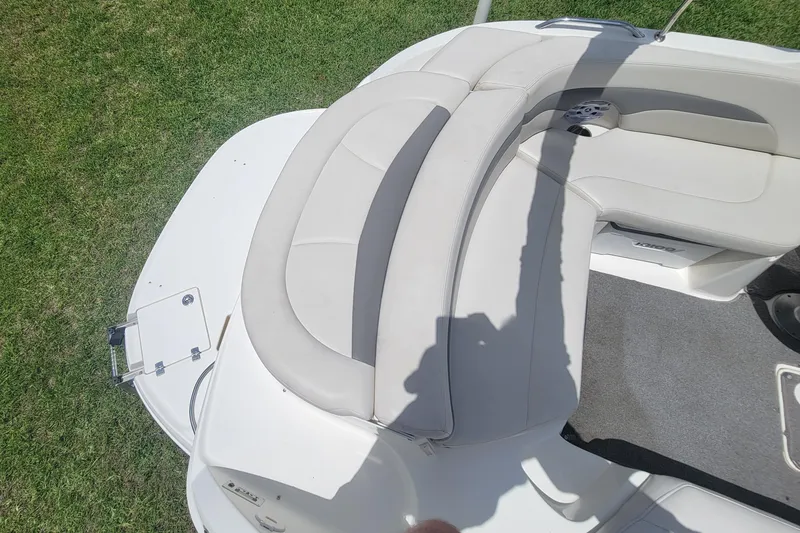 Slide: The Image of 2007 Chaparral Sunesta 214 boat interior with white seating and carpeted floor. - 24