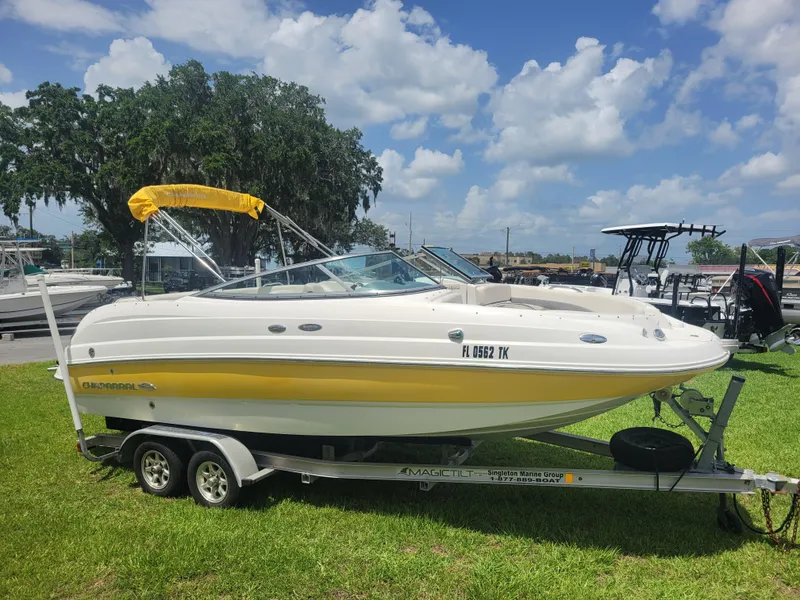 Slide: The Image of 2007 Chaparral Sunesta 214 boat with yellow accents on a trailer, parked on grass. - 3