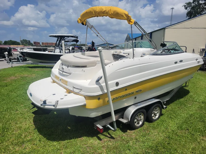 Slide: The Image of 2007 Chaparral Sunesta 214 boat on trailer, parked on grass under a cloudy sky. - 4