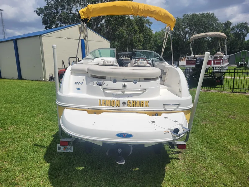 Slide: The Image of 2007 Chaparral Sunesta 214 boat, rear view, parked on grass with yellow canopy. - 5