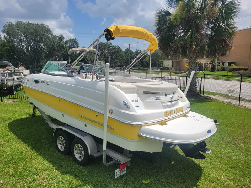 Slide: The Image of 2007 Chaparral Sunesta 214 boat with yellow accents on a trailer, parked on grass. - 6