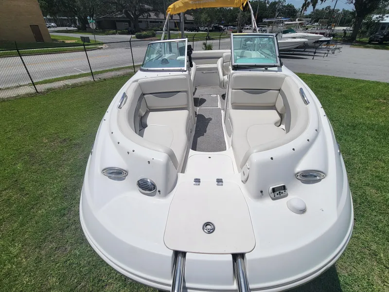 Slide: The Image of 2007 Chaparral Sunesta 214 boat with open bow seating, parked on grass. - 7