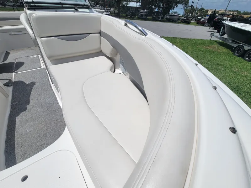 Slide: The Image of 2007 Chaparral Sunesta 214 boat interior with white cushioned seating and gray flooring. - 9