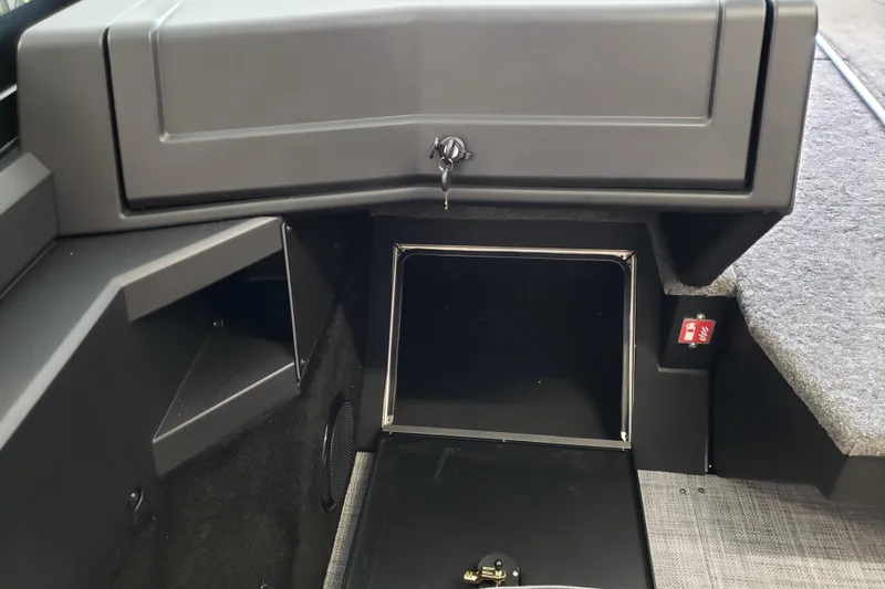 Slide: The Image of 2026 Alumacraft Competitor 175 Sport interior storage compartment with lock and carpeted flooring. - 11