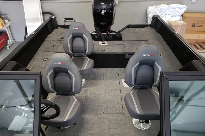 Slide: The Image of 2026 Alumacraft Competitor 175 Sport interior with gray seating and spacious layout. - 6