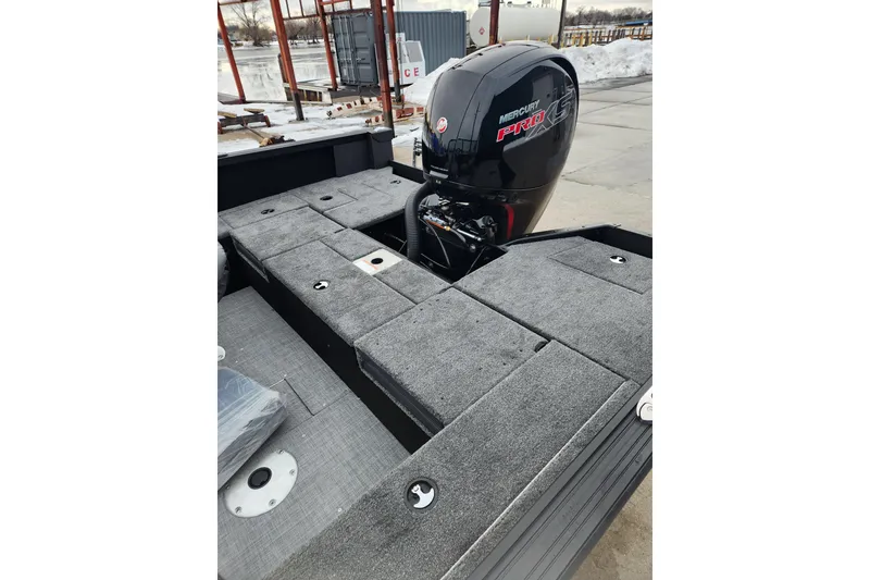 Slide: The Image of 2026 Alumacraft Competitor 175 Sport boat with Mercury Pro XS engine, docked near snowy shore. - 8