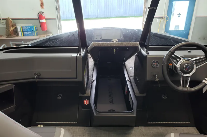 Slide: The Image of Interior of 2026 Alumacraft Competitor 175 Sport boat, featuring steering wheel and dashboard. - 9