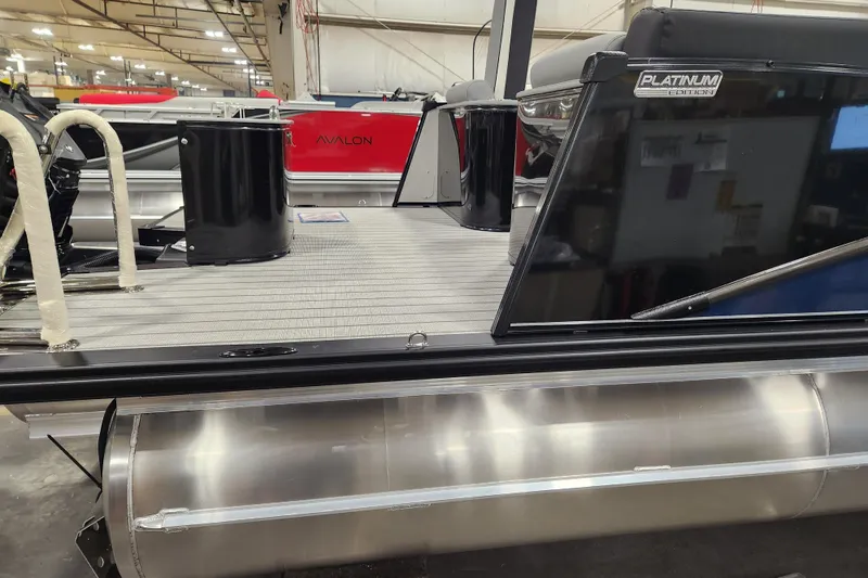 Slide: The Image of 2026 Tahoe Pontoon 25 Cascade Quad Lounge interior with protective plastic covers. - 12