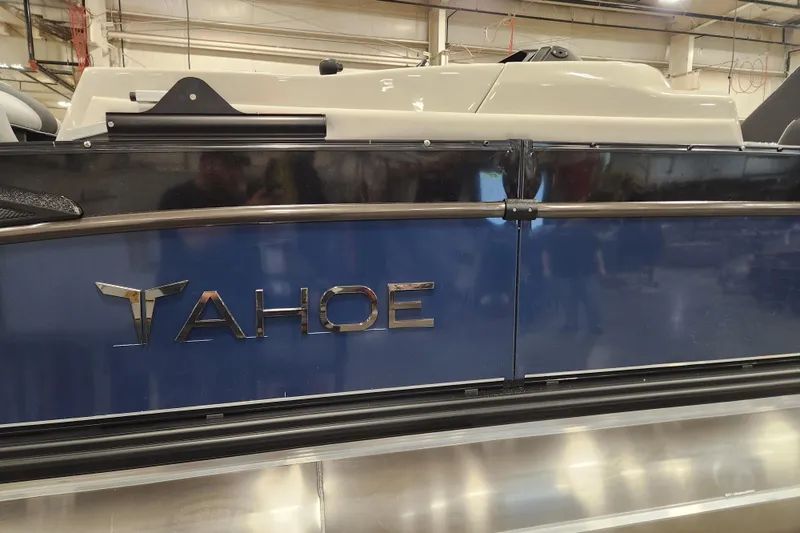 Slide: The Image of 2026 Tahoe Pontoon 25 Cascade Quad Lounge with powerful V8 engine in a workshop setting. - 23