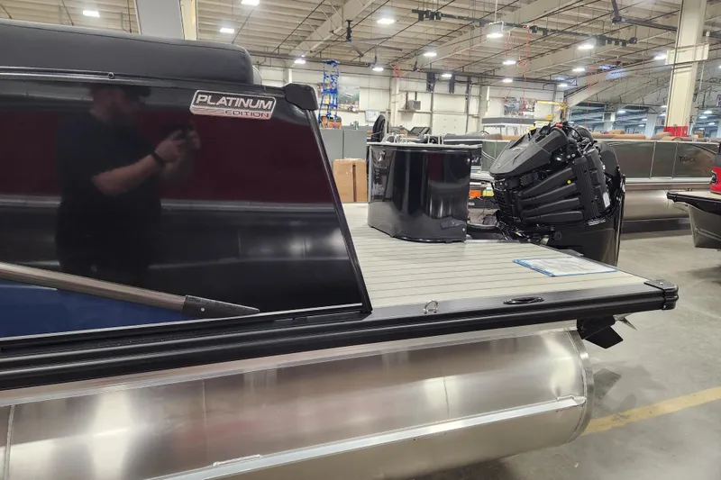 Slide: The Image of 2026 Tahoe Pontoon 25 Cascade Quad Lounge, blue exterior, indoor showroom display. - 29