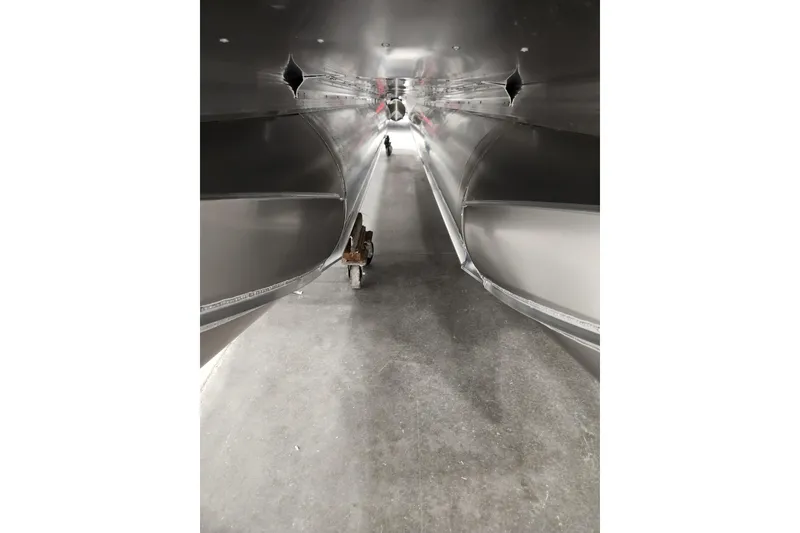 Slide: The Image of 2026 Tahoe Pontoon 25 Cascade Quad Lounge in a showroom, showcasing sleek design and modern features. - 30