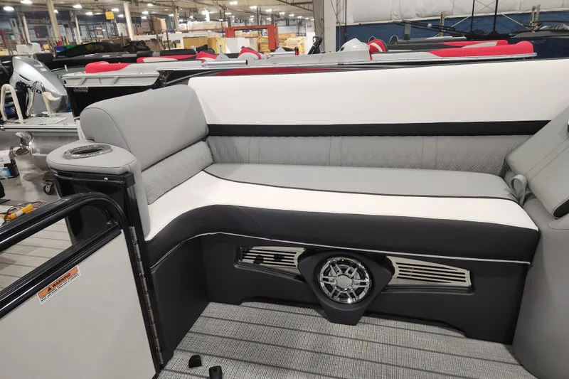 Slide: The Image of 2026 Tahoe Pontoon 25 Cascade Quad Lounge interior with stylish seating and speaker system. - 42