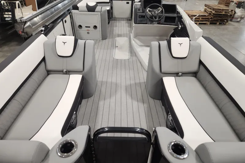 Slide: The Image of 2026 Tahoe Pontoon 25 Cascade Quad Lounge interior with sleek gray seating and modern dashboard. - 47