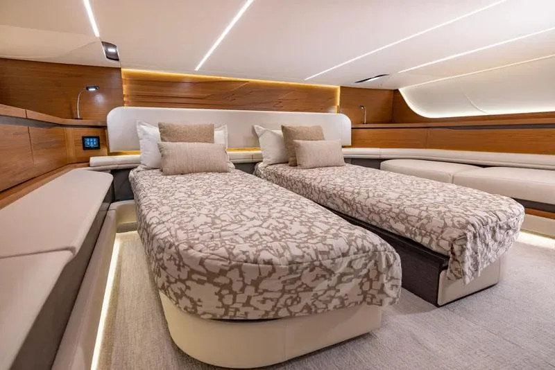 Slide: The Image of Manufacturer Provided Image: Luxurious 2026 Tiara Yachts 56 LS cabin interior with twin beds and elegant wood finishes. - 15