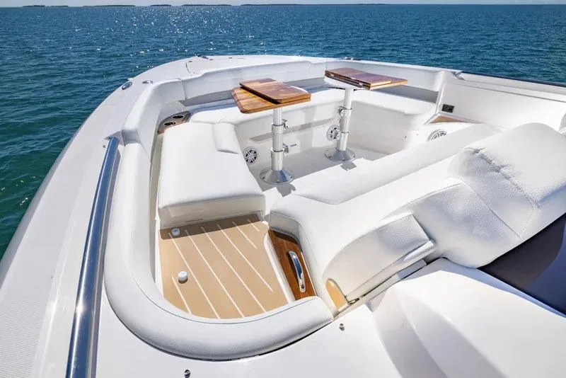 Slide: The Image of Manufacturer Provided Image: Luxurious seating area on 2026 Tiara Yachts 56 LS, featuring elegant white upholstery and wooden tables. - 4