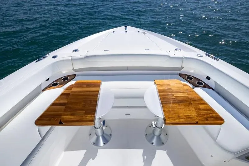 Slide: The Image of Manufacturer Provided Image: 2026 Tiara Yachts 56 LS luxury yacht deck with wooden tables and ocean view. - 5