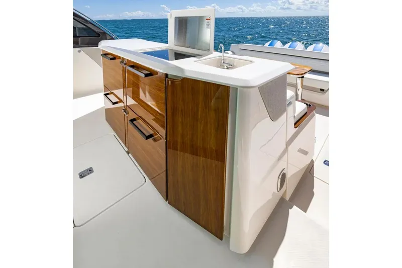Slide: The Image of Manufacturer Provided Image: Luxurious 2026 Tiara Yachts 56 LS outdoor kitchen with ocean view, featuring sleek wood cabinetry. - 7