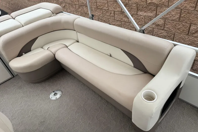 Slide: The Image of 2004 Sun Tracker Party Barge 21 interior seating with beige and cream upholstery. - 16