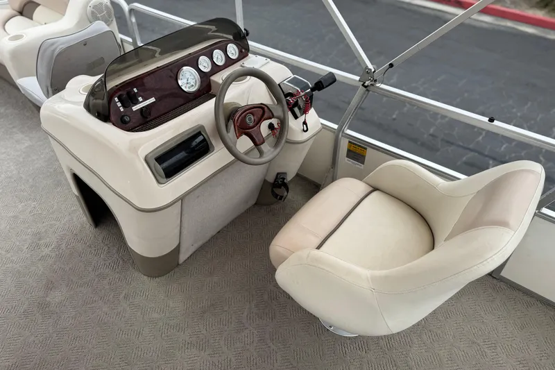 Slide: The Image of 2004 Sun Tracker Party Barge 21 helm with steering wheel and gauges. - 19