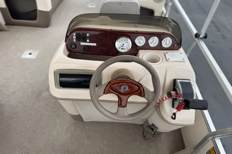 Slide: The Image of 2004 Sun Tracker Party Barge 21 dashboard with steering wheel and instrument panel. - 20