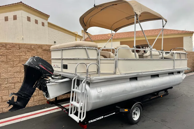 Slide: The Image of 2004 Sun Tracker Party Barge 21 pontoon boat on trailer, beige canopy, outboard motor. - 5