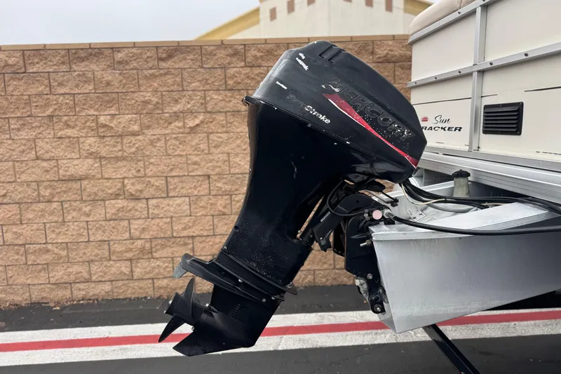 Slide: The Image of 2004 Sun Tracker Party Barge 21 with Mercury outboard motor, parked by a brick wall. - 6