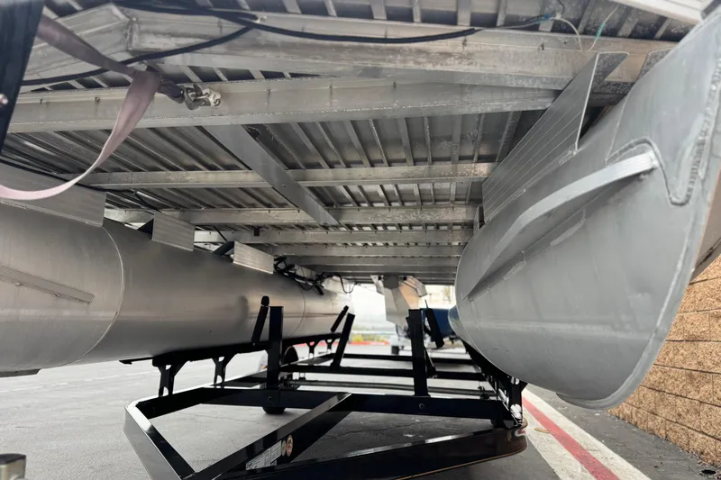 Slide: The Image of Underneath view of a 2004 Sun Tracker Party Barge 21 pontoon boat on a trailer. - 7