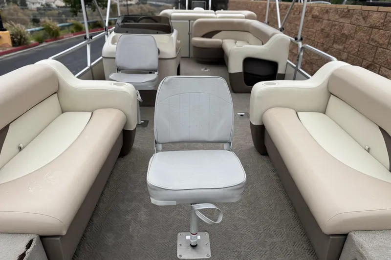 Slide: The Image of 2004 Sun Tracker Party Barge 21 interior with beige seating and central chair. - 8