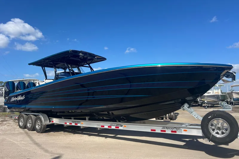 The Image of 2026 Nor-Tech 390 Sport Center Console boat on trailer under clear blue sky. - 1