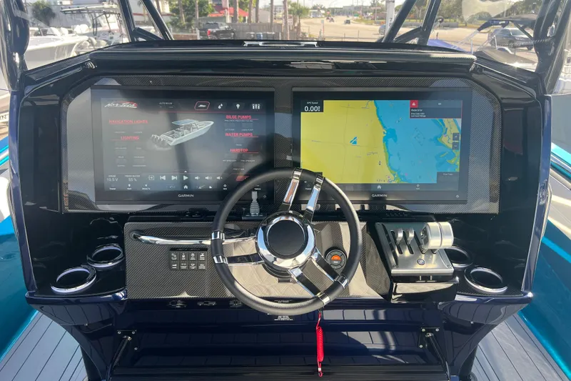 Slide: The Image of 2026 Nor-Tech 390 Sport Center Console dashboard with dual Garmin displays and steering wheel. - 15