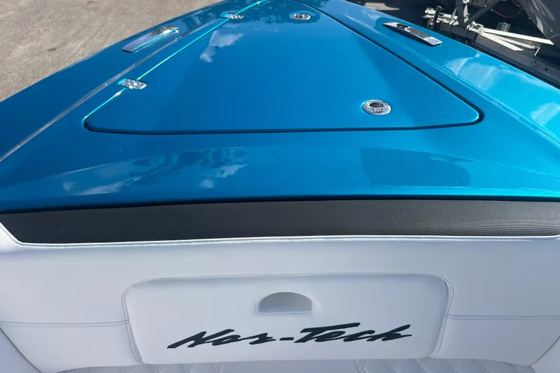 Slide: The Image of 2026 Nor-Tech 390 Sport Center Console boat with sleek blue and white design. - 17