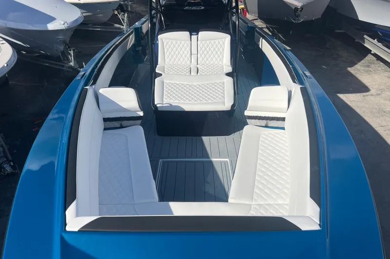 Slide: The Image of 2026 Nor-Tech 390 Sport Center Console with white seating and sleek blue exterior. - 19