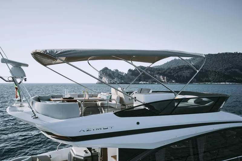 Slide: The Image of Manufacturer Provided Image: 2025 Azimut Fly 53 yacht cruising on serene waters with scenic mountain backdrop. - 4