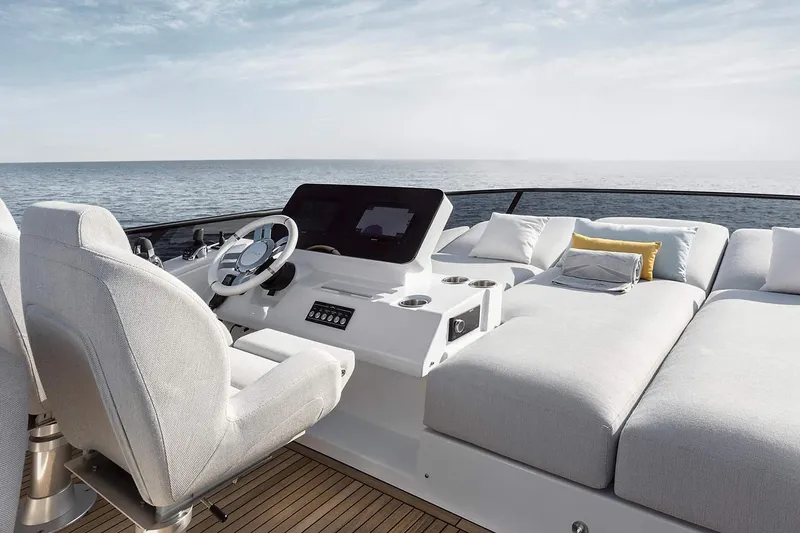 Slide: The Image of Manufacturer Provided Image: 2025 Azimut Fly 53 yacht deck with helm, luxurious seating, and ocean view. - 8