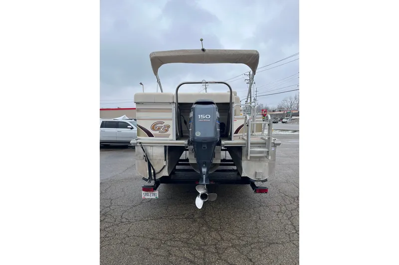 Slide: The Image of Rear view of 2005 GEN3 LX3 22C boat with outboard motor and canopy. - 2