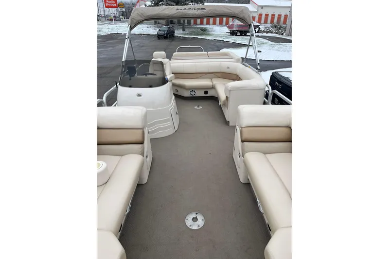Slide: The Image of 2005 GEN3 LX3 22C pontoon boat with beige seating and canopy in parking lot. - 3