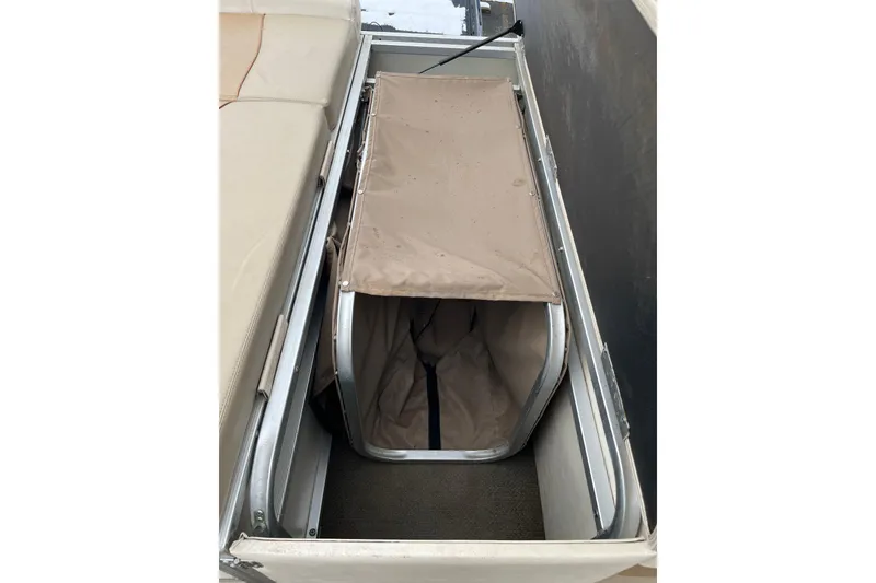 Slide: The Image of Storage compartment in a 2005 GEN3 LX3 22C boat with beige cover. - 4