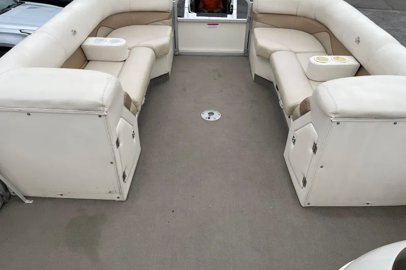 Slide: The Image of Interior of 2005 GEN3 LX3 22C boat with beige seating and cup holders. - 7