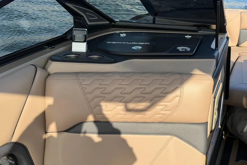 Slide: The Image of 2025 Centurion Ri245 boat interior with beige leather seating and cup holders. - 10