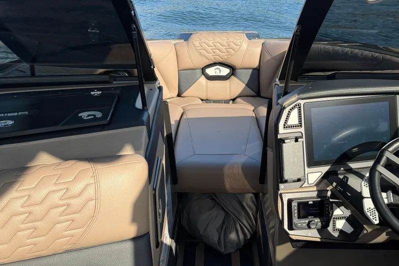 Slide: The Image of 2025 Centurion Ri245 boat interior with modern dashboard and luxurious seating. - 11