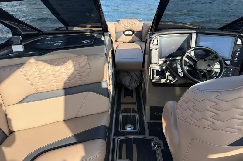 Slide: The Image of 2025 Centurion Ri245 boat interior with luxurious seating and advanced dashboard controls. - 12