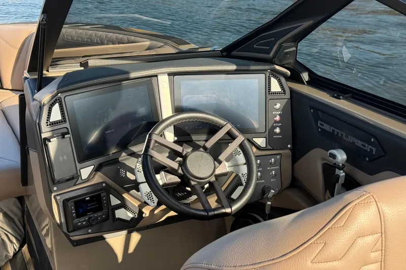Slide: The Image of 2025 Centurion Ri245 boat dashboard with modern controls and steering wheel. - 9