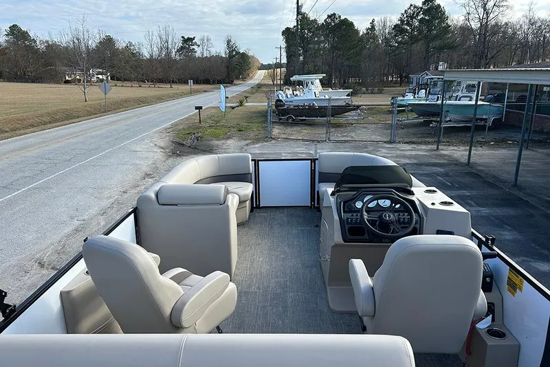 Slide: The Image of 2026 Bentley Pontoons Legacy 223 Swingback interior with plush seating and modern dashboard. - 10