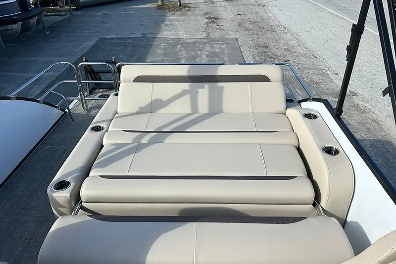 Slide: The Image of 2026 Bentley Pontoons Legacy 223 Swingback with luxurious beige seating and cup holders. - 14